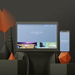 A laptop and smartphone displaying a website with the text "WELCOME TO MY SHOP" are placed on a black cloth-covered table. Surrounding the devices, reflecting sleek web design aesthetics, are modern decor items including black vases, a geometric orange sculpture, and orange fern leaves against a dark background.
