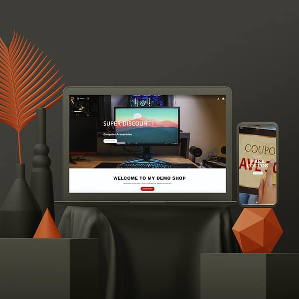 A stylish setup with a laptop displaying a discount banner over a computer accessories section and the text "Welcome to My Demo Shop." Nearby is a smartphone showing a coupon. Decorative black and orange elements add an elegant touch to this sleek web design scene.